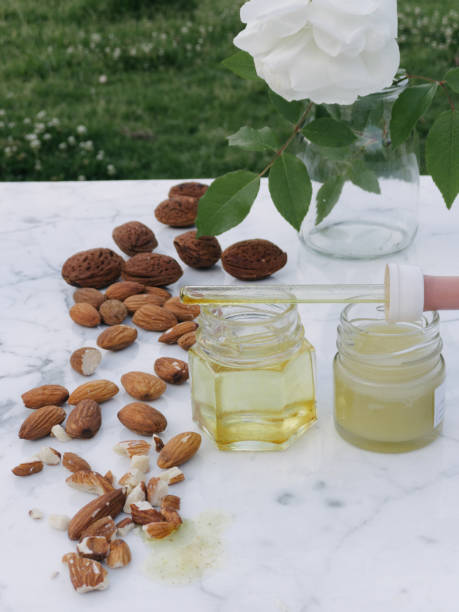istock Natural medicine, elements to make ointment for pains. Almonds, 1218654000