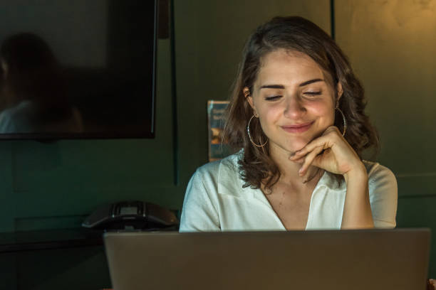 istock Young caucasian woman working with her notebook at home alone 1218654798