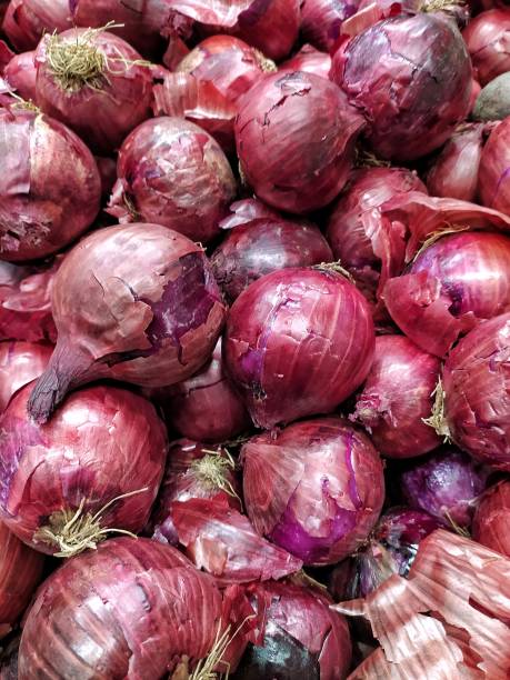 istock Red onions shot all together in a gondola. 1218655052