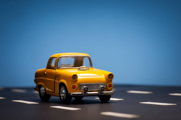 istock Yellow toy car on a blue background. 1218656259
