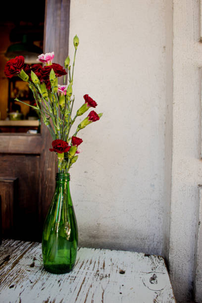 istock still life carnation in a glass bottle in a vintage table 1218658250