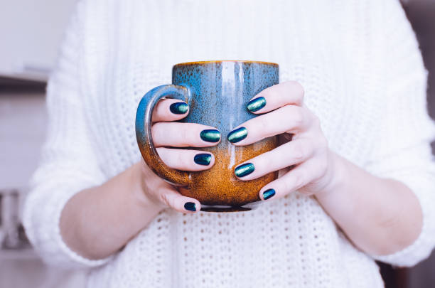 istock Woman holding red tea cup 1218659331