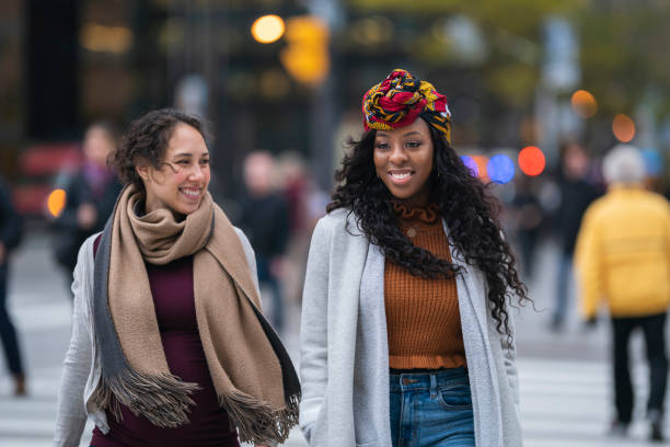 istock Two female friends walking through city 1218659362