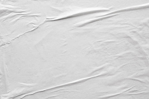 istock Blank white crumpled and creased paper poster texture background 1218659407