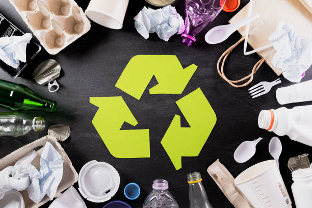 istock Top view of Different garbage materials with recycling symbol on black background. Recycle, World Environment Day, go green and Eco concept 1218661276