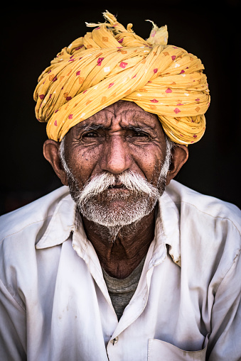 Jaisalmer, India- April 11 2017: Portrait of Rajasthani man wearing traditional clothes at the city of Jaisalmer.