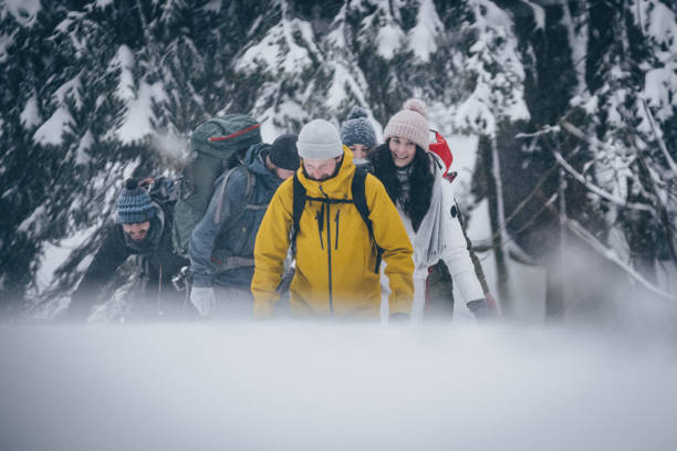 istock Friends hike through snowy forest 1218664197