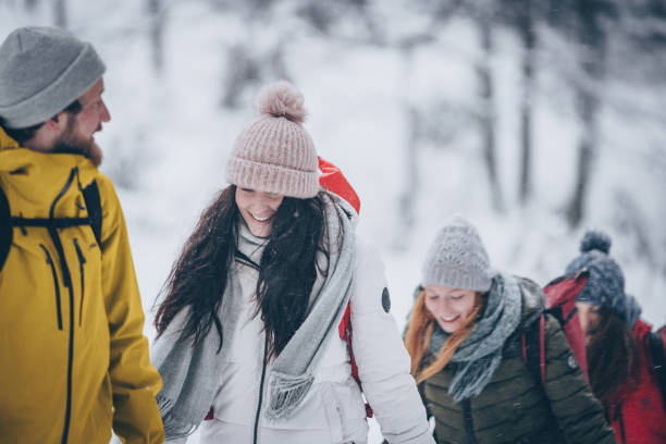 istock Friends hike through snowy forest 1218664227
