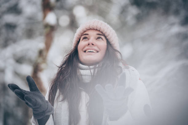 istock Young woman hikes through snowy forest 1218664382