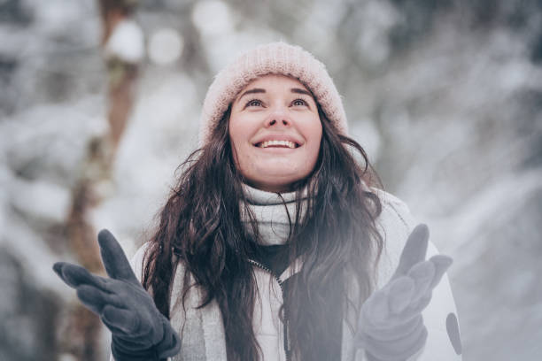 istock Young woman hikes through snowy forest 1218664386