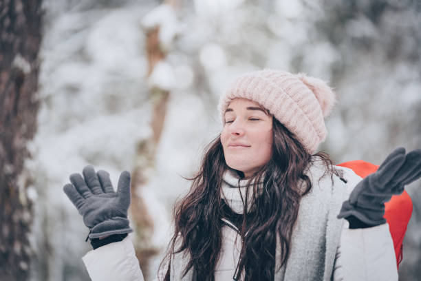 istock Young woman hikes through snowy forest 1218664914