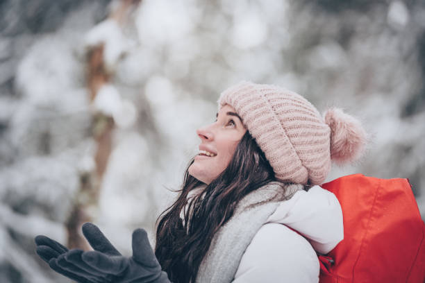 istock Young woman hikes through snowy forest 1218664935