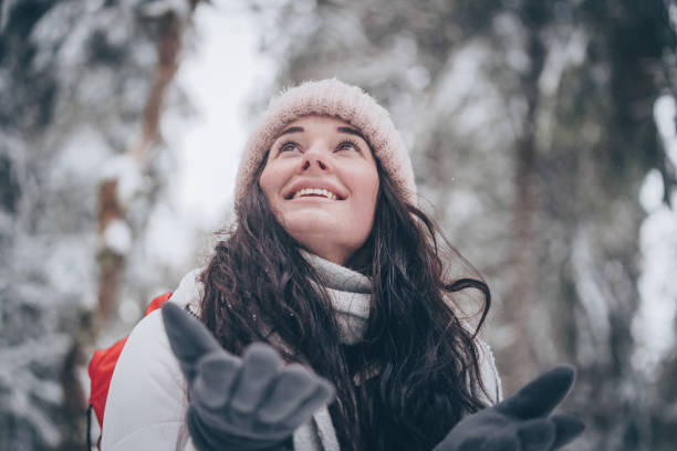 Young woman hikes through snowy forest