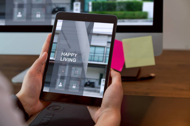 istock Hand holding digital tablet and using computer with showing website for rent and sale of houses online. 1218666509