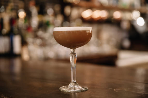 istock A creamy coffee cocktail with a bar in the background 1218669264