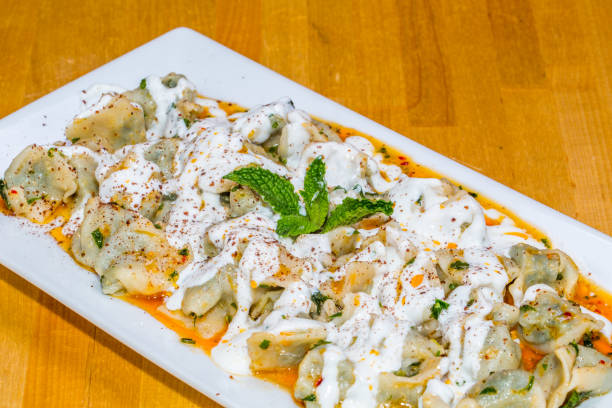 istock Turkish Manti with red pepper, tomato sauce, yogurt and mint (dumplings) 1218676603