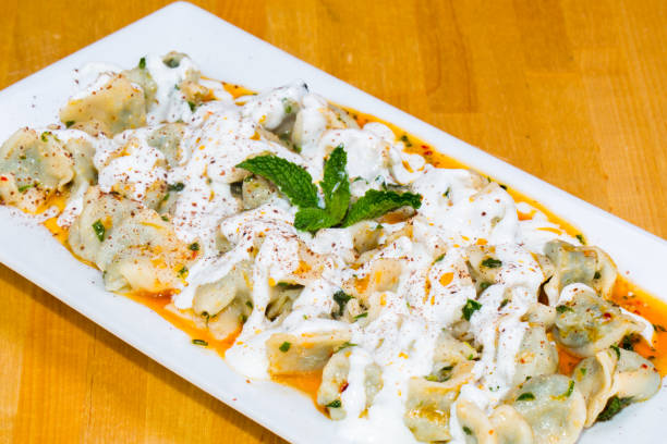 istock Turkish Manti with red pepper, tomato sauce, yogurt and mint (dumplings) 1218676605