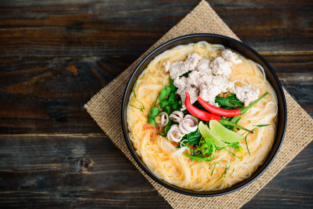 istock Spicy rice noodles soup with spices and herbs (Thai Tom Yum) 1218678193