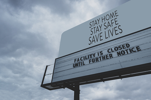 Signage for a public facility closure during the COVID-19 pandemic. Stay Home, Stay Safe, Save Lives on billboard above.