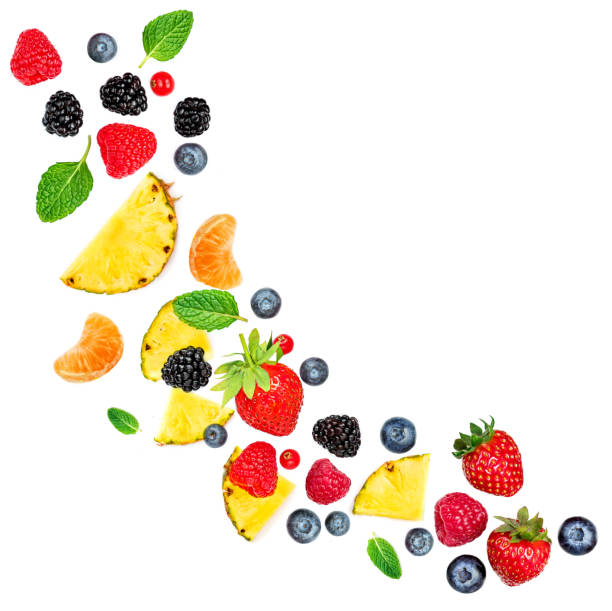 Summer tropival pattern with Fresh  berries isolated on white background, top view. Flying berries - Strawberry, Raspberry, Blueberry and Mint leaf, flat lay