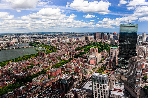 A panoramic view of Boston - Massachusetts in the foreground with the Charles Riverto the left of  the photograph .