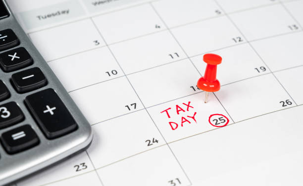 istock Tax day written on a calendar with a red pushpin. 1218684935