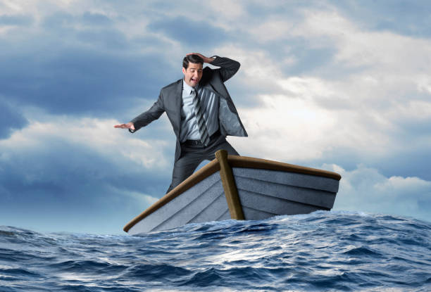 istock Businessman Balancing In Boat In Rough Seas 1218685149