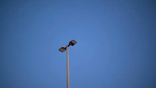 Picture of some lights in a parking lot taken on a clear day in Raleigh, NC