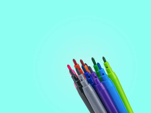 istock Colored markers in the corner of the image on a turquoise background. 1218689601