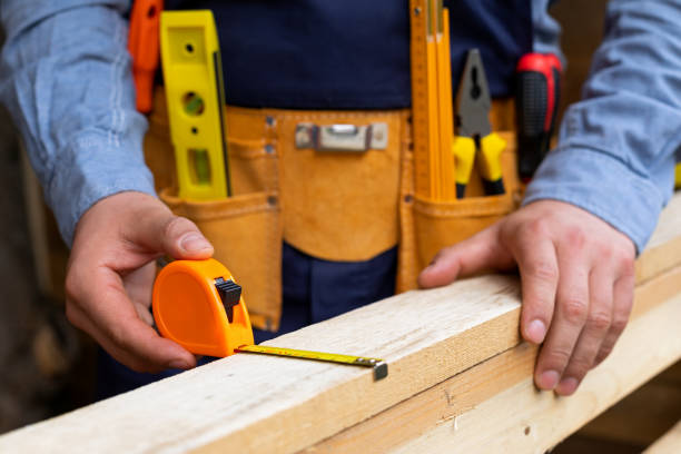 istock Carpenter's hands measuring plank 1218689691