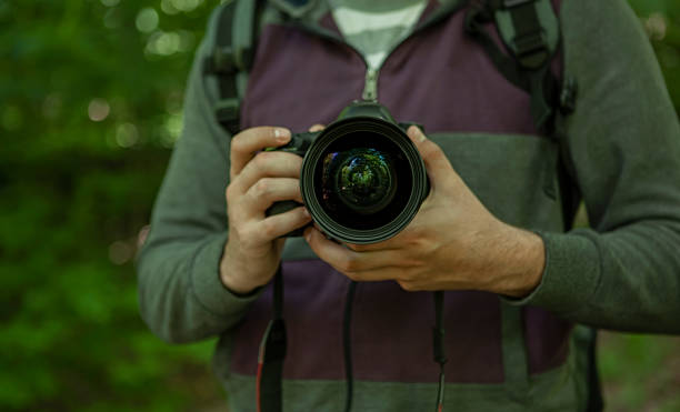 istock photographer holds the camera in his hands 1218689918