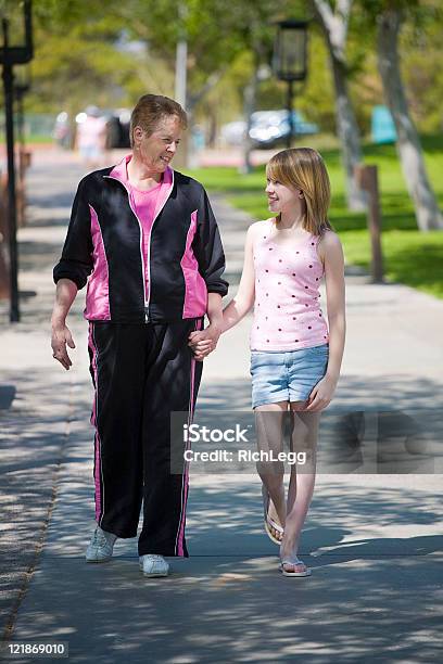 Grandmother Walking With Granddaughter Stock Photo - Download Image Now - Active Lifestyle, Active Seniors, Adolescence