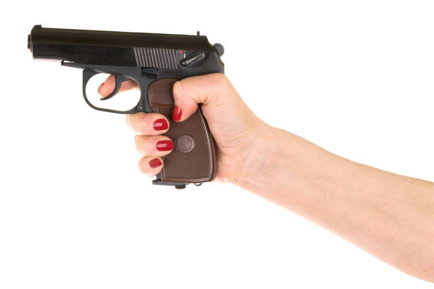istock female hand holding gun 1218692854