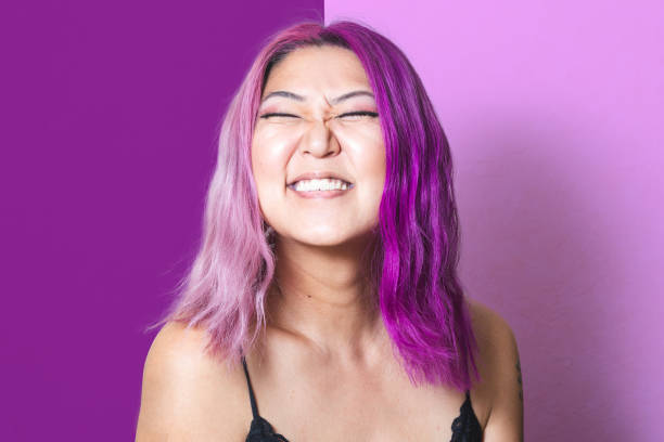 Pink and Purple Portrait A Korean woman with pink and purple hair grins at the camera cheesy grin stock pictures, royalty-free photos & images
