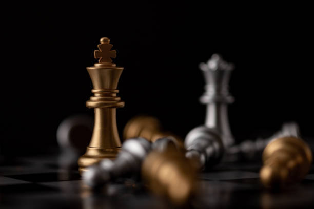 istock King and Queen standing in the midst of falling chess 1218695126