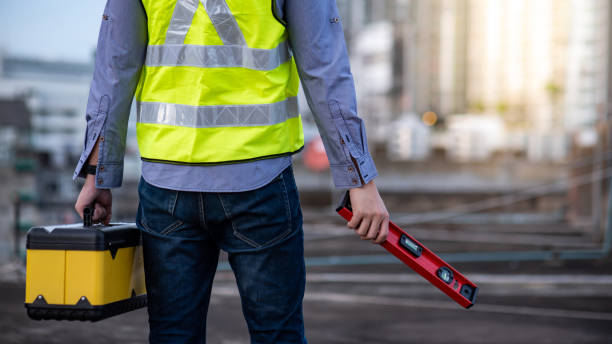 istock Worker man holding spirit level tool and box 1218698943
