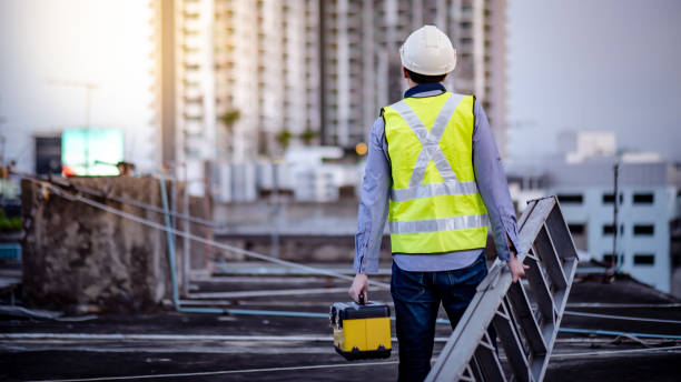 istock Worker man carrying aluminium ladder and tool box 1218699231