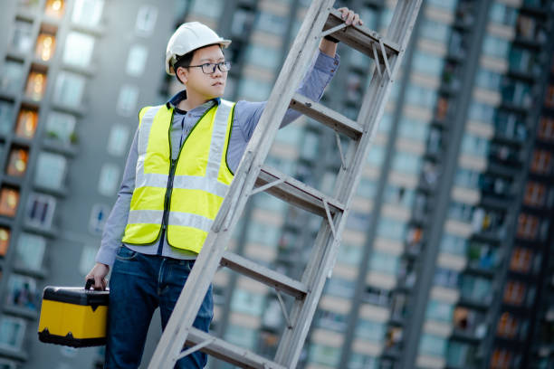 istock Worker man carrying aluminium ladder and tool box 1218699233