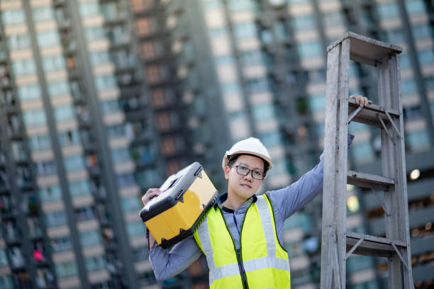 istock Worker man carrying aluminium ladder and tool box 1218699234