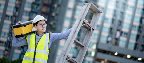 istock Worker man carrying aluminium ladder and tool box 1218699235
