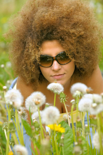 istock Relaxing Woman In A Dandelion Field 1218703849