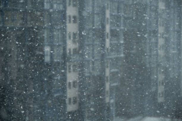 istock Winter snowfall on the background of a multi-storey building. 1218704193