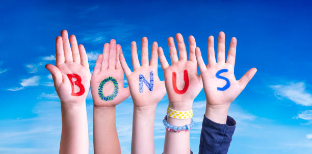 istock Children Hands Building Word Bonus, Blue Sky 1218704889