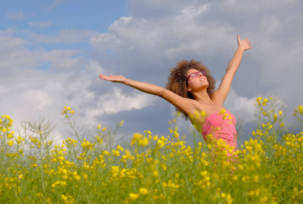 istock Woman Standing In A Rapeseed Field 1218704982