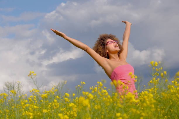 istock Woman Standing In A Rapeseed Field 1218704988