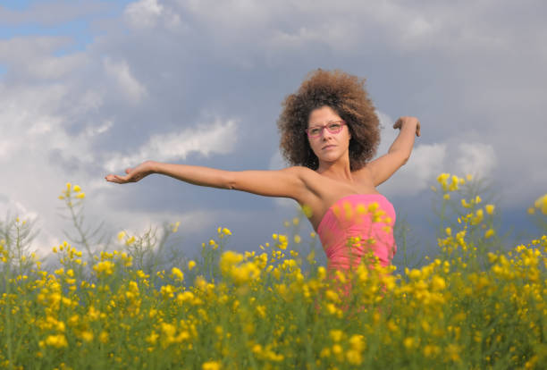 istock Woman Standing In A Rapeseed Field 1218704992