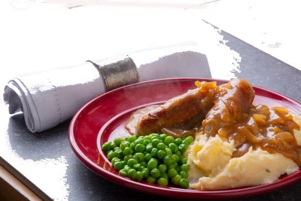 istock Bangers and mash potatoes and peas 1218705098