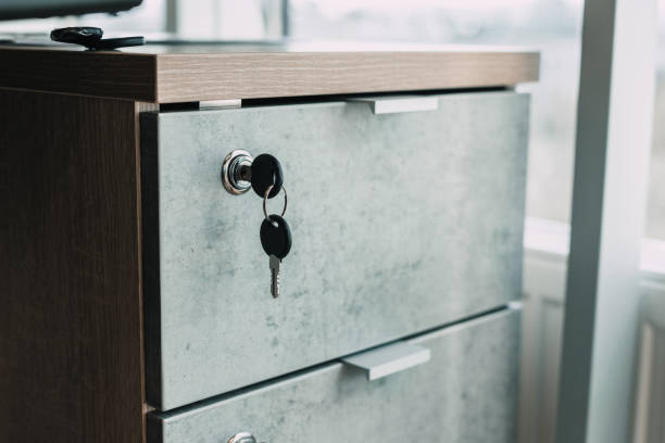 armadietto chiuso a chiave in un ufficio moderno. concetto di sicurezza - keyhole door wood office foto e immagini stock