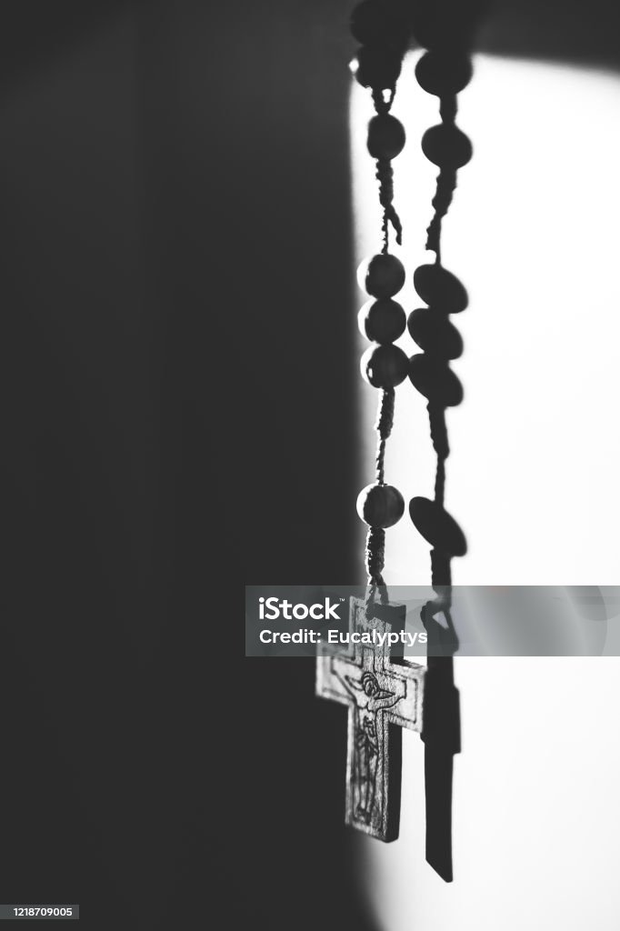 Rosary, holy cross, black and hite Rosary on white background. No people. Close shot. Krakow in Poland. Black and white Rosary Beads Stock Photo