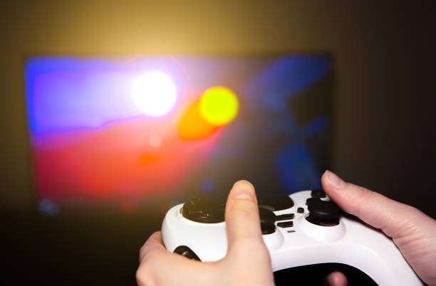 istock Man is playing video games at home. Gamepad in hands. Self isolation time. Entertainment during the quarantine period. 1218709165